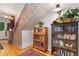 Charming entryway with wood staircase, built-in bookcases, and ample natural light welcomes you into the home at 2721 Curtis St, Denver, CO 80205