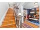 Elegant foyer with wooden staircase, ornate banister, and decorative lighting, flowing into the dining area at 2721 Curtis St, Denver, CO 80205