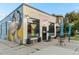 Coffee shop exterior with a vibrant mural, outdoor seating, and inviting curb appeal at 2721 Curtis St, Denver, CO 80205
