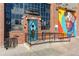 Intriguing building facade with colorful mural, unique entrance, and industrial design elements at 2721 Curtis St, Denver, CO 80205