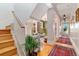 Inviting hallway with hardwood floors, decorative rugs, and a staircase at 2721 Curtis St, Denver, CO 80205