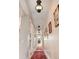 Hallway with a traditional design, vintage pendant lights, and original hardwood floors with a decorative carpet at 2721 Curtis St, Denver, CO 80205