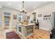Spacious kitchen featuring a large center island, stainless steel appliances, and decorative lighting fixtures at 2721 Curtis St, Denver, CO 80205