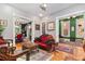 Sophisticated living room with hardwood floors, vintage furniture, and decorative molding, showcasing the home's historic charm at 2721 Curtis St, Denver, CO 80205