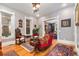 Elegant living room boasts hardwood floors, classic seating, and views into adjacent rooms at 2721 Curtis St, Denver, CO 80205