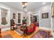 Comfortable living room with hardwood floors, a vintage sofa and view to dining room at 2721 Curtis St, Denver, CO 80205