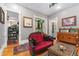 Stylish living room featuring a tufted red sofa, ornate wood accents, and decorative rugs, exuding vintage charm at 2721 Curtis St, Denver, CO 80205
