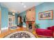 Bright living room with original hardwood floors, brick fireplace, and vintage furnishings at 2721 Curtis St, Denver, CO 80205