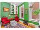 Bright sitting room with green walls, comfortable seating, and a cozy fireplace offers a relaxing retreat at 2721 Curtis St, Denver, CO 80205