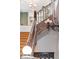 Rustic staircase with detailed wood railing and decorative wall-mounted light fixture, showcasing the home's historic charm at 2721 Curtis St, Denver, CO 80205