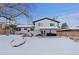 Spacious backyard with snow, tree, and a swingset at 7513 E Bates Dr, Denver, CO 80231