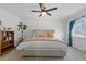 Bright bedroom with a plush bed, bookcase, and window coverings at 7513 E Bates Dr, Denver, CO 80231