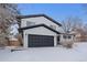 Modern two-story home with black and white exterior and snow covered landscaping at 7513 E Bates Dr, Denver, CO 80231