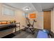 Basement home gym with exercise bike and weight bench at 7513 E Bates Dr, Denver, CO 80231