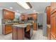 Modern kitchen with granite countertops and wooden cabinetry at 7513 E Bates Dr, Denver, CO 80231