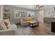 Bright living room featuring hardwood floors and comfy seating at 7513 E Bates Dr, Denver, CO 80231