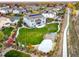 Aerial view of a backyard featuring a playground, lush lawn, and an outdoor dining area at 2258 Front Range Rd, Erie, CO 80516