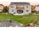 Large home with a landscaped backyard featuring a patio with outdoor seating and play area, perfect for entertaining at 2258 Front Range Rd, Erie, CO 80516