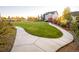 Expansive grassy backyard offers a serene walking path, garden beds, and views of the neighborhood homes at 2258 Front Range Rd, Erie, CO 80516