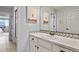 Bright bathroom featuring unique artwork, white cabinetry, mosaic backsplash, and an integrated sink at 2258 Front Range Rd, Erie, CO 80516