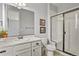 Bathroom with a vanity, toilet, framed artwork, and glass-enclosed shower with bench at 2258 Front Range Rd, Erie, CO 80516
