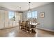 Bright dining area featuring a large window, elegant chandelier, and stylish decor perfect for Gathering meals at 2258 Front Range Rd, Erie, CO 80516