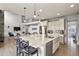 Open-concept kitchen with a large island, modern appliances, and a seamless view into the living area at 2258 Front Range Rd, Erie, CO 80516