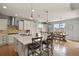 Spacious kitchen with a large island, white cabinetry, stainless steel appliances, and an adjacent dining area at 2258 Front Range Rd, Erie, CO 80516