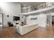 Bright living room with hardwood floors, a comfortable sofa, a large TV, and elegant decor accents at 2258 Front Range Rd, Erie, CO 80516