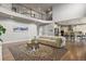Open-concept living room showcasing a balcony, modern furnishings, and seamless flow into the kitchen at 2258 Front Range Rd, Erie, CO 80516