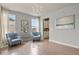 Elegant living room featuring hardwood floors, stylish seating, and a chandelier at 2258 Front Range Rd, Erie, CO 80516