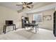 Cozy office space features neutral walls, carpet, contemporary furnishings, and natural light from a window at 2258 Front Range Rd, Erie, CO 80516