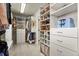 Well-organized walk-in closet with custom shelving and drawers for optimal storage at 2258 Front Range Rd, Erie, CO 80516