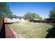 Expansive backyard with a lush green lawn, wooden fence, and manicured garden area, ideal for relaxation and recreation at 7870 Magnolia St, Commerce City, CO 80022