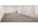 Spacious basement area with carpet flooring and access to a bathroom at 7870 Magnolia St, Commerce City, CO 80022