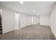 Spacious basement with neutral carpet and a door that provides access to a bathroom at 7870 Magnolia St, Commerce City, CO 80022