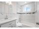 Beautiful bathroom with marble-style tile, modern fixtures, and a shower-tub combination at 7870 Magnolia St, Commerce City, CO 80022