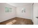 This bedroom has hardwood floors and two windows providing lots of natural light at 7870 Magnolia St, Commerce City, CO 80022
