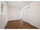 Bedroom featuring hardwood floors and a closet with sliding doors at 7870 Magnolia St, Commerce City, CO 80022