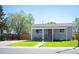 Adorable single-story home with manicured lawn, a welcoming porch, and inviting curb appeal at 7870 Magnolia St, Commerce City, CO 80022