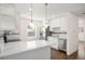 Well-lit kitchen showcasing white cabinetry, stainless steel appliances, and modern pendant lights at 7870 Magnolia St, Commerce City, CO 80022