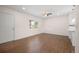 Bright living room featuring hardwood floors, a ceiling fan, and a large window at 7870 Magnolia St, Commerce City, CO 80022