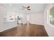 Open-concept living room with wood floors seamlessly transitioning into the modern kitchen at 7870 Magnolia St, Commerce City, CO 80022