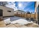 Home exterior features a wood privacy fence, air conditioning units, and a partial snow covering at 372 S Humboldt St, Denver, CO 80209