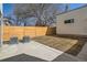 A small backyard with a wood fence, air conditioning units, and small patch of grass at 372 S Humboldt St, Denver, CO 80209