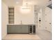 Wet bar in basement features modern cabinetry, stone countertop, and wine fridge at 372 S Humboldt St, Denver, CO 80209