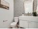 Charming half bathroom featuring patterned tile wall, floating vanity, and modern fixtures at 372 S Humboldt St, Denver, CO 80209