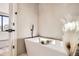 Modern white bathtub with white marble tile and matte black fixtures at 372 S Humboldt St, Denver, CO 80209