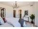 Bright bedroom with a decorative chandelier, walk-in closet, and crisp white bedding at 372 S Humboldt St, Denver, CO 80209