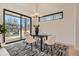 Bright dining area with modern lighting, a black table, seating for four, and sliding glass doors at 372 S Humboldt St, Denver, CO 80209